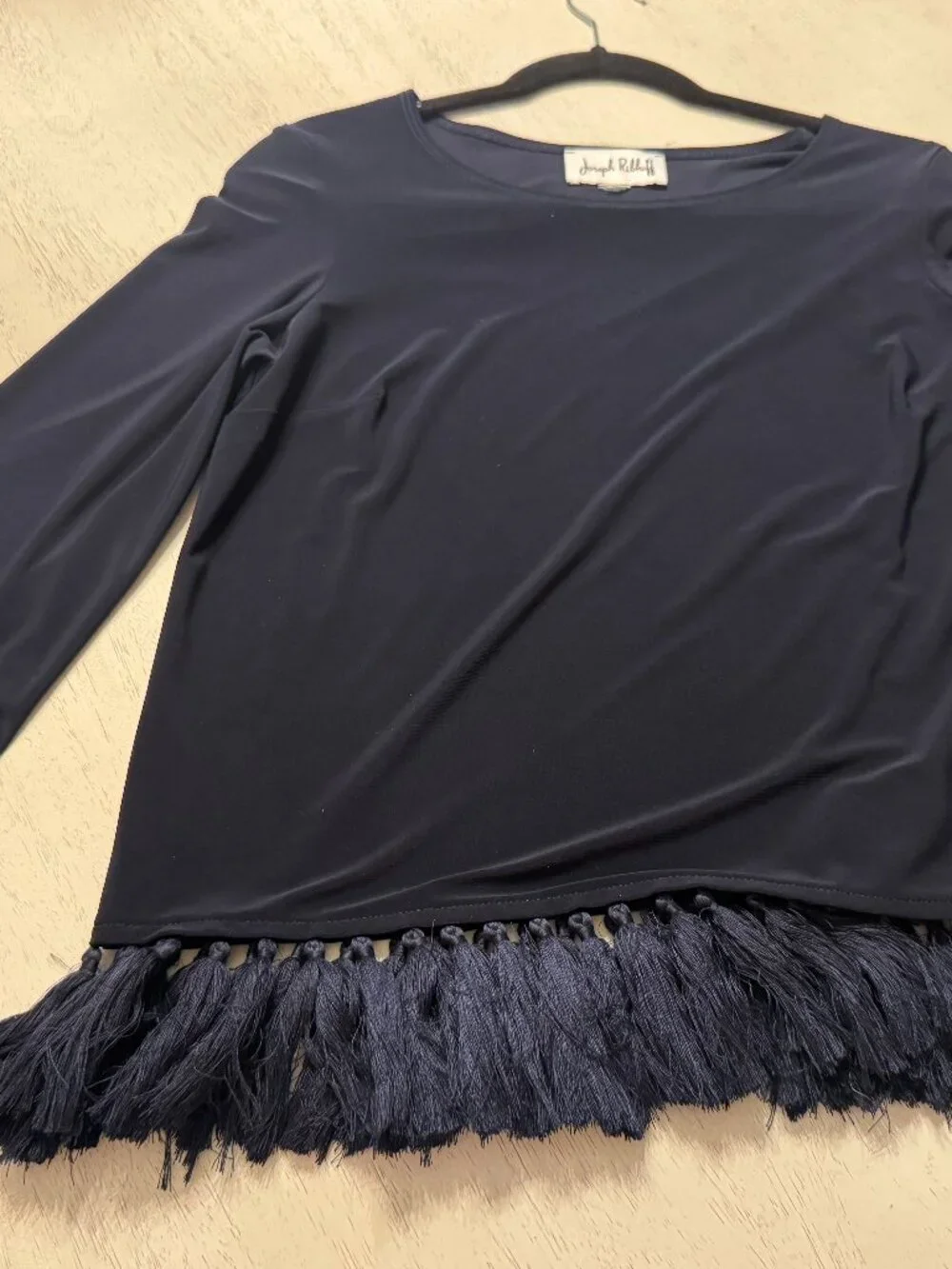 Joseph Ribkoff silky top size M with distinctive fringe along cuffs and hem
